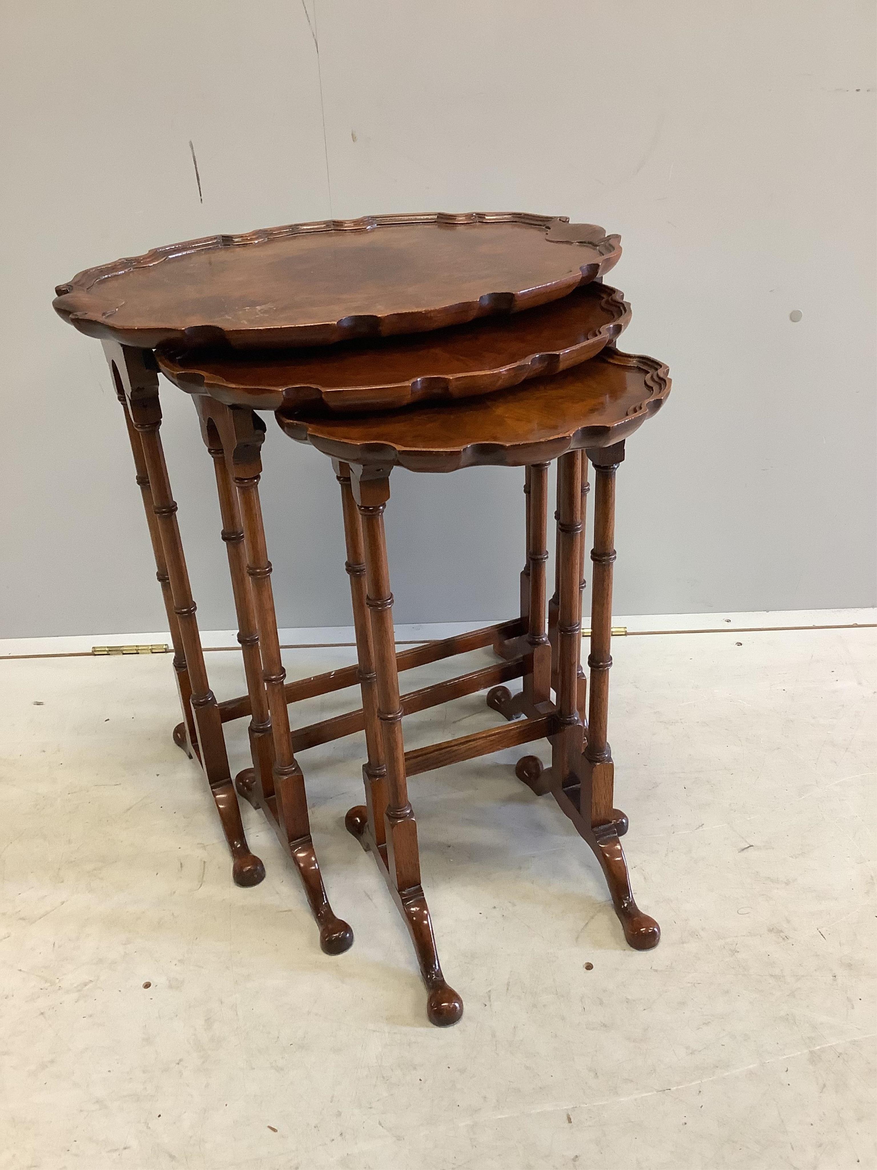 A nest of three burr walnut oval tea tables, width 56cm, depth 38cm, height 62cm. Condition - fair